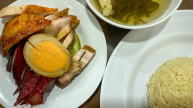 fried pork with vegetable sauce and vegetables on white plate