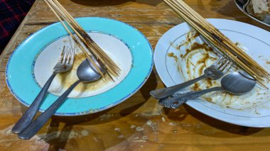 set of empty wooden spoons and cutlery on white background