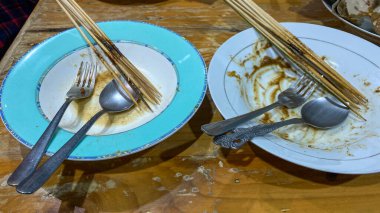 vintage cutlery, knife, fork and spoon on a wooden table.