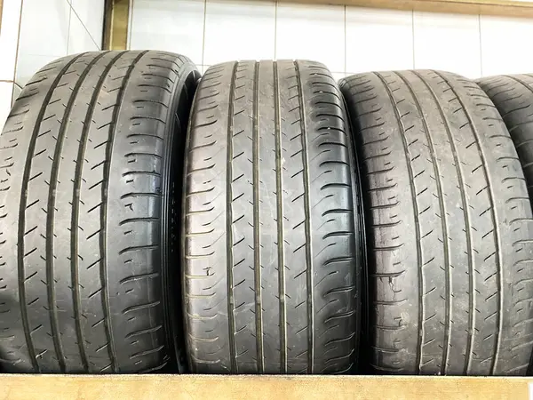 Group of new tires for sale in a line. A new tire is placed on the tire storage rack in the car workshop. Be prepared for vehicles that need to change tires.