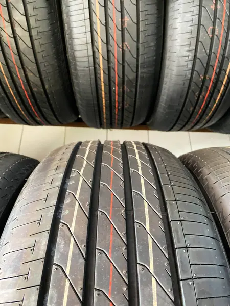 Group of new tires for sale in a line. A new tire is placed on the tire storage rack in the car workshop. Be prepared for vehicles that need to change tires.