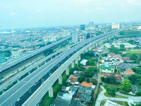 stock image Cityscape in Bekasi, Indonesia in daylight elevated view. Aerial view of Bekasi City housing, toll road and buildings.