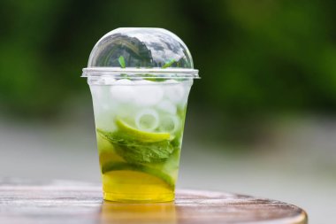 Öğleden sonra soğuk mojito içen bir plastik standı (buz, nane, maden suyu, kireç)