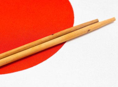 Japon bayrağının arka planında suşi çubukları var.