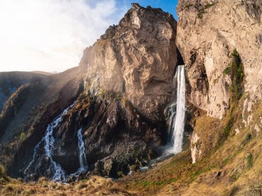 View of the Sultan waterfall in the Elbrus region, photo was taken on a sunny autumn day. Panoramic view.