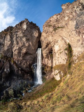 View of the Sultan waterfall in the Elbrus region, photo was taken on a sunny autumn day. Vertical view.