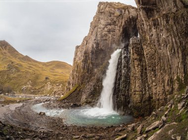 Gil-Su waterfall in wide autumn valley in North Caucasus, Russia. Beautiful autumn landscape.