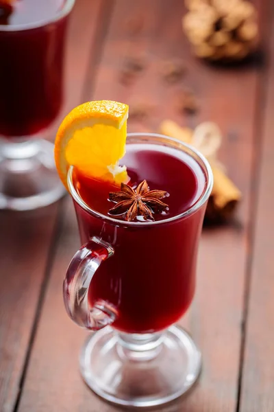 Christmas mulled wine with anise and orange slice. Mulled wine, cinnamon sticks and cloves on wooden boards. Traditional hot drink at Christmas time