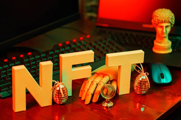 stock image NFT inscription with ancient sculpture and an artificial arm. NFT (Non-Fungible Token) and computer equipment in orange-green neon light. Surreal NFT concept