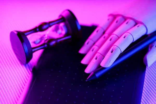 Artificial intelligence creates digital content on a graphics tablet. Artificial hand holds a pen. Concept of time and digital content