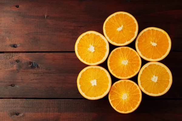 Halves of oranges on a wooden boards. Juicy orange halves for making juice on a wooden table. Copy space