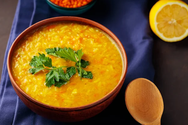 stock image Bowl of lentil soup on a blue linen napkin. Red lentil soup with fresh parsley. Traditional middle eastern food. Close up