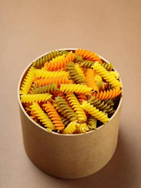 Tricolor Fusilli Pasta Cardboard Box Raw Fusilli Pasta Beige Background — Stock Photo, Image