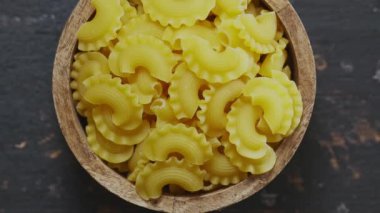 Ham Creste di Gallo Pasta in Wooden Bowl on Dark Vintage Table, Top View