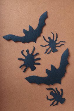 Siyah Kağıt Kesme Yarasaları ve Örümcekler Cadılar Bayramı Dekorasyonu için Kahverengi Arkaplanda Ayarlandı