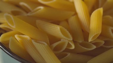 Mutfak tezgahında seramik kasede kurutulmuş makarna.