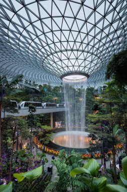 Singapur havalimanı yağmur girdabı ve yemyeşil bitki örtüsü arasında demiryolu