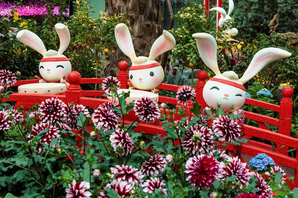 Group of cute and adorable cartoon-like rabbits emerging from flowers at gardens by the bay - Singapore.