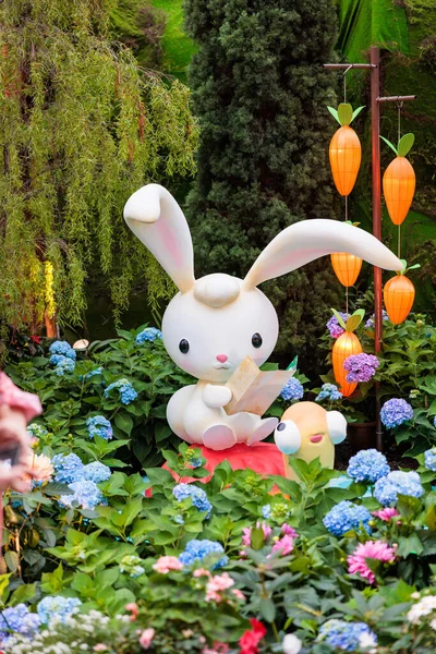 Cute and adorable cartoon-like rabbit emerging from flowers at gardens by the bay - Singapore.