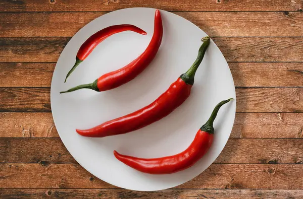 red chili pepper-red chili-red chili in plate-peppers in plate-red chili on plate-red chili on table