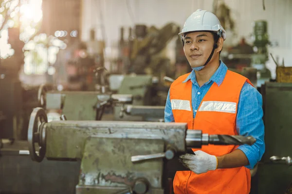 happy Asian male worker work in heavy metal industry factory enjoy smile portrait