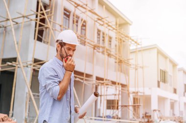 supervisor builder worker work in construction site. Architect home project chief engineer radio with floor plan.