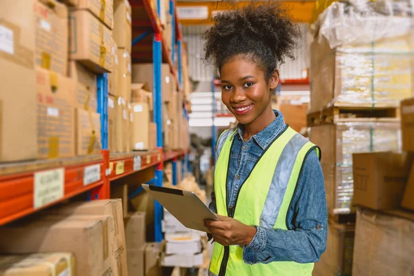 woman worker black African girl teen working in cargo warehouse inventory employee staff portrait happy smile
