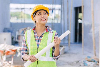 Engineer Architect builder Asian smart woman worker pride in work at construction site happy smiling.