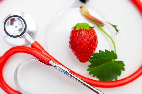 strawberry high nutrition vitamin for good health concept. closeup strawberries fruit with stethoscope.