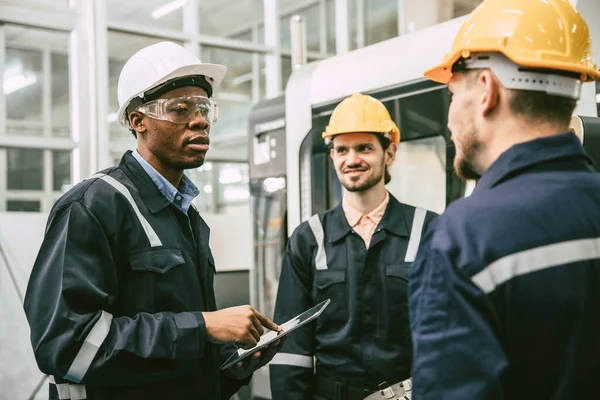 African black male engineer team leader talking with team worker college group in modern factory