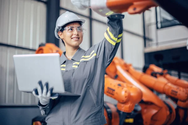 Engineer woman team worker work in Machine Robotic modern Automation Industry. Mechanic staff employee in metal factory.