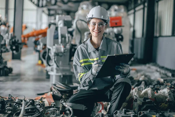 Engineer woman team worker work in Machine Robotic modern Automation Industry. Mechanic staff employee in metal factory.