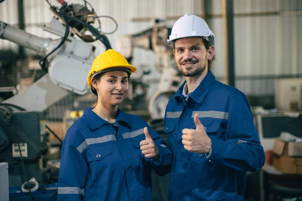 Portrait engineer technician team happy smile thumbs up. Engineers worker enjoy working together in heavy industry.