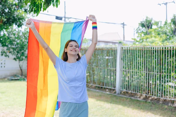 幸せな女性が虹の旗を掲げてLgbtトランスジェンダーの同性愛者平等の権利運動を支援 — ストック写真