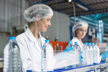 İçme suyu fabrikasında çalışan bir işçi. Kadın işçiler, beyaz işçiler, temiz üretim bandı, maden suyu fabrikası..