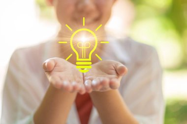 happy people with lightbulb icon bright in hand support for creativity life ignition for saving energy eco power for environmental activity concept clipart