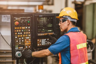 Asyalı işçi CNC Metal Makinesi Otomatik Dijital Torna 'da çalışıyor. Mühendis Kurulumu Fabrikada Programlama Değirmen Makinesi Çalıştır.