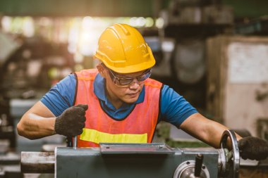 Ağır Metal Fabrikası 'nda CNC Değirmen Makinesi kullanan genç Asyalı Teknisyen Personel İşçisi.