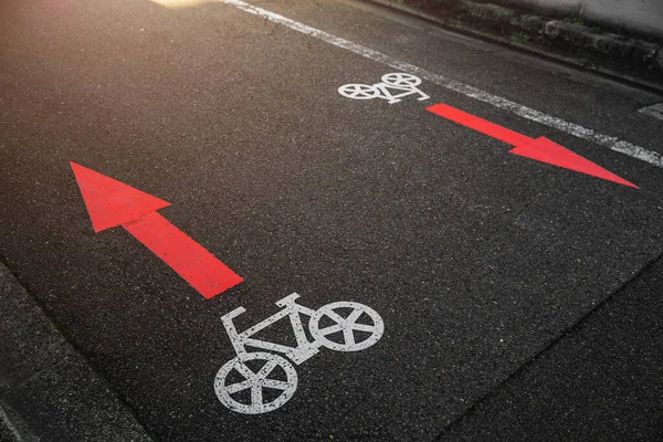 bike lane two ways sign direction arrow symbol paint on asphalt road in japan city metro