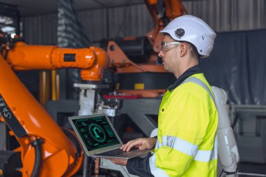 Bilgisayar kontrolü kullanan mühendis erkek. Robot kol makinesi kullanıyor. man programlama robotik test kontrol servisi