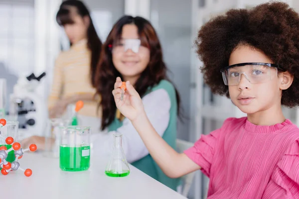 Afro black kid diversity children playing in science chemical lab for learning education in school with friend