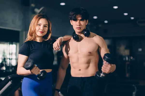 Portrait Happy sport man and woman bodybuilding advertising athlete model muscle training in fitness gym sport club