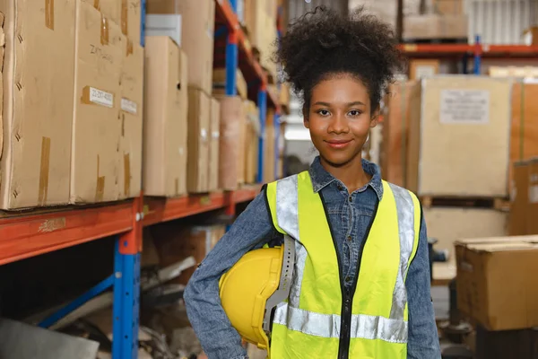 Happy african black young woman worker work in cargo warehouse inventory employee staff portrait smiling