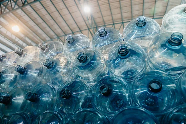 Water gallon pile stock. Plastic PET drinking bottle in drink water plant factory store in clean hygiene storage warehouse.