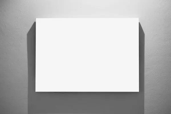 blank painting canvas hanging display on gallery wall with light shadow white copy space for advertising graphics element background