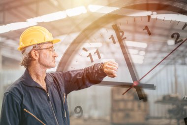 Engineer senior mananger worker looking at wristwatch overlay time clock face. Industry factory working hours concept. clipart