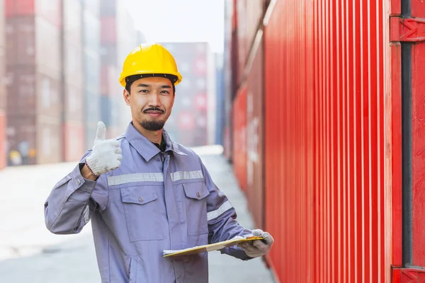 Portrait happy Japanese male engineer worker working in container port cargo. Japan shipping logistics industry customs staff people.