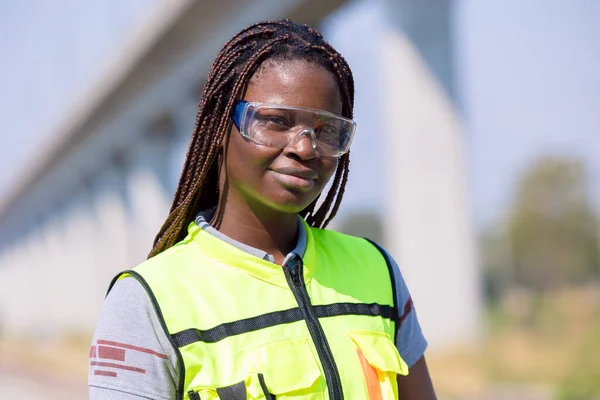 Portrait African black engineer women worker work checking service in train railway tracks construction site in transportation industry