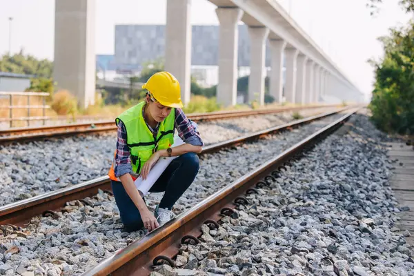 Engineer railway tracks construction service team working on site survey checking and maintenance inspection train track for safety