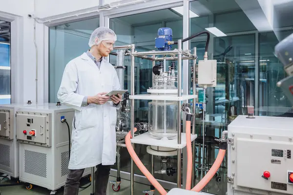 stock image Scientist staff working with Equipment in Science Lab. Medical factory staff. Pharmaceutical Plants Process.